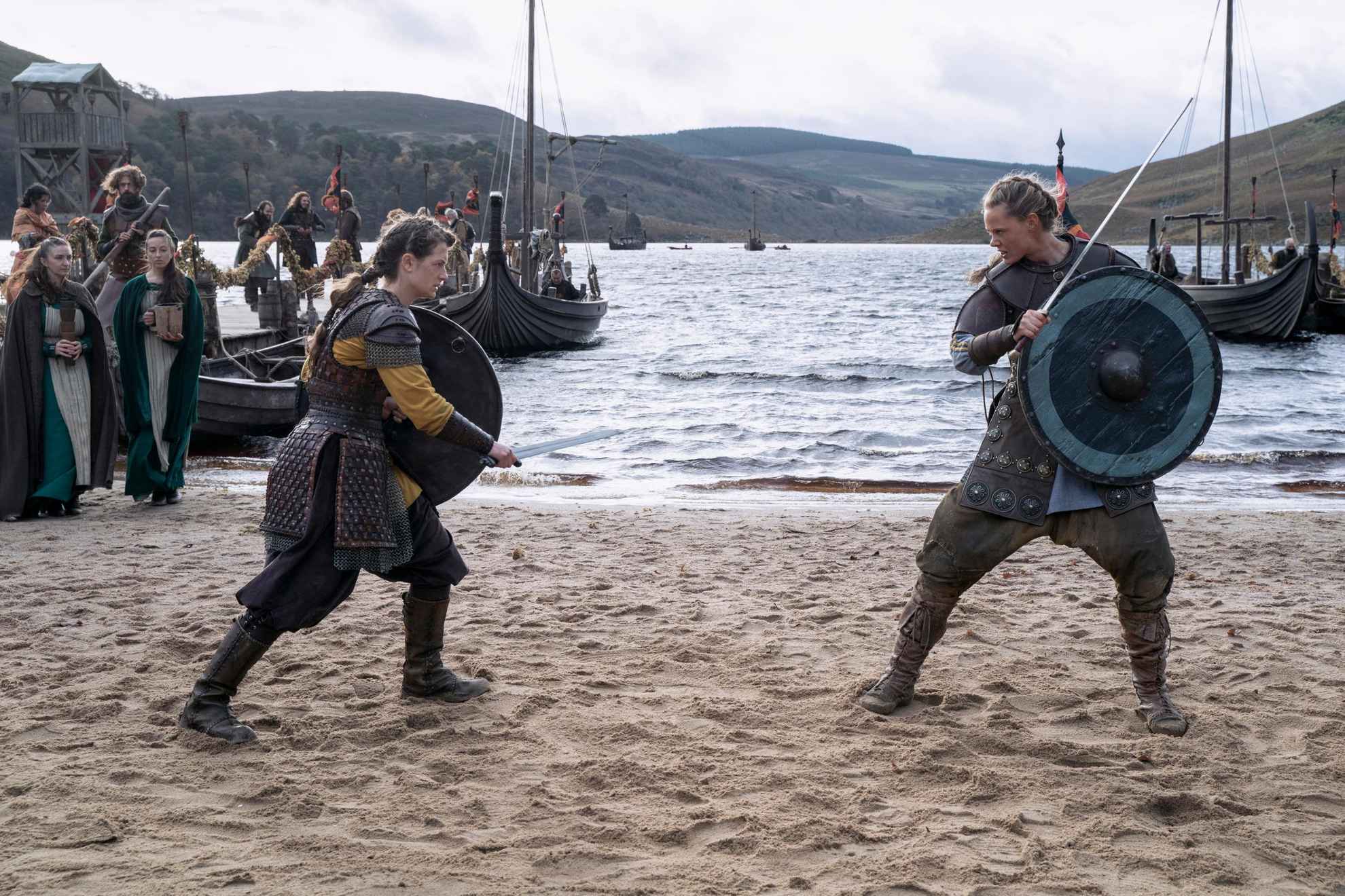 Two viking women standing on a beach preparing to fight each other. From the tv series Vikings: Valhalla.